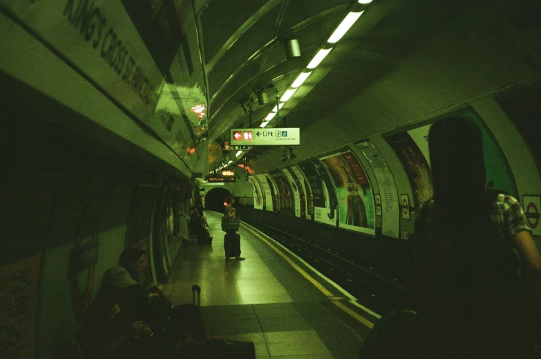 people at a subway station in the dark