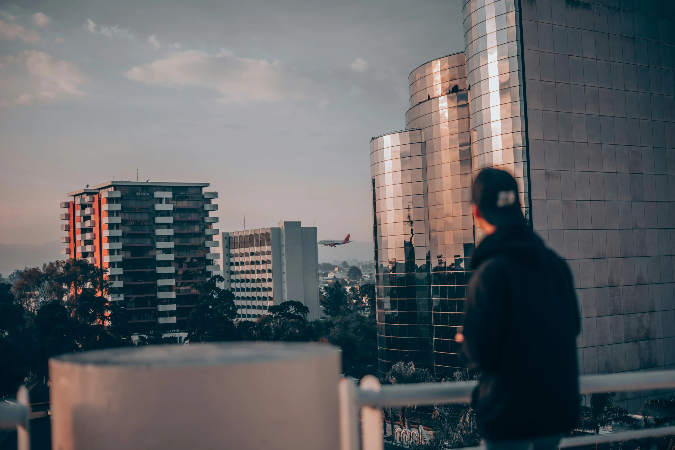 the person stands outside the high rise building