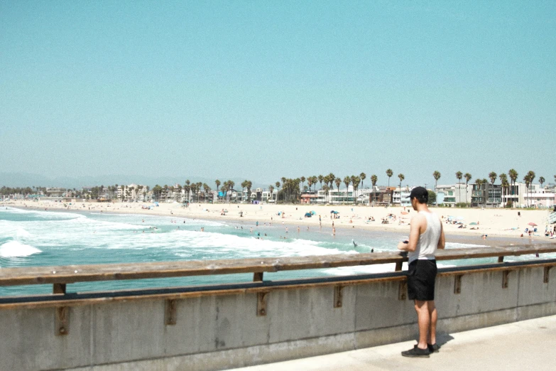 a person standing near a beach next to the ocean