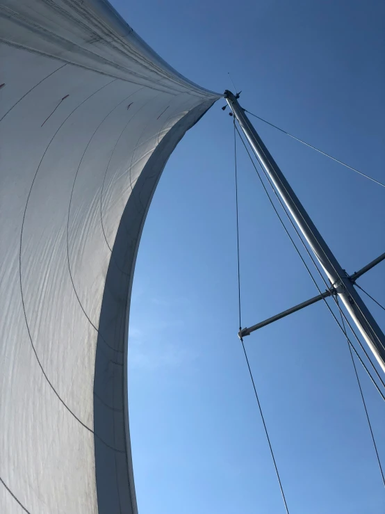 a wind sail blowing over on a sunny day