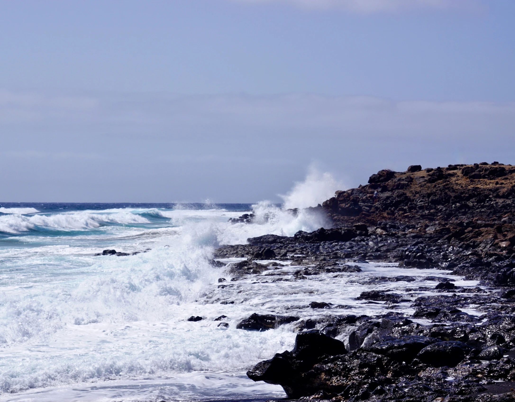 the waves have washed on the rocky coast