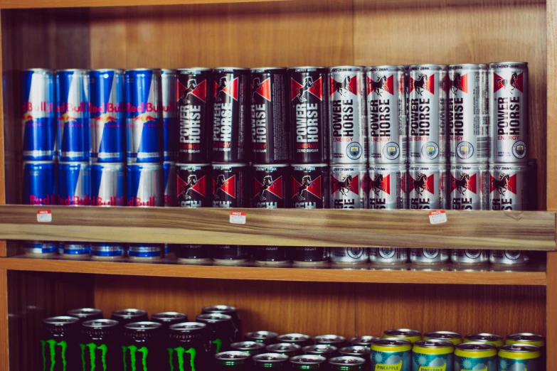 a lot of cans of different beer on the shelves