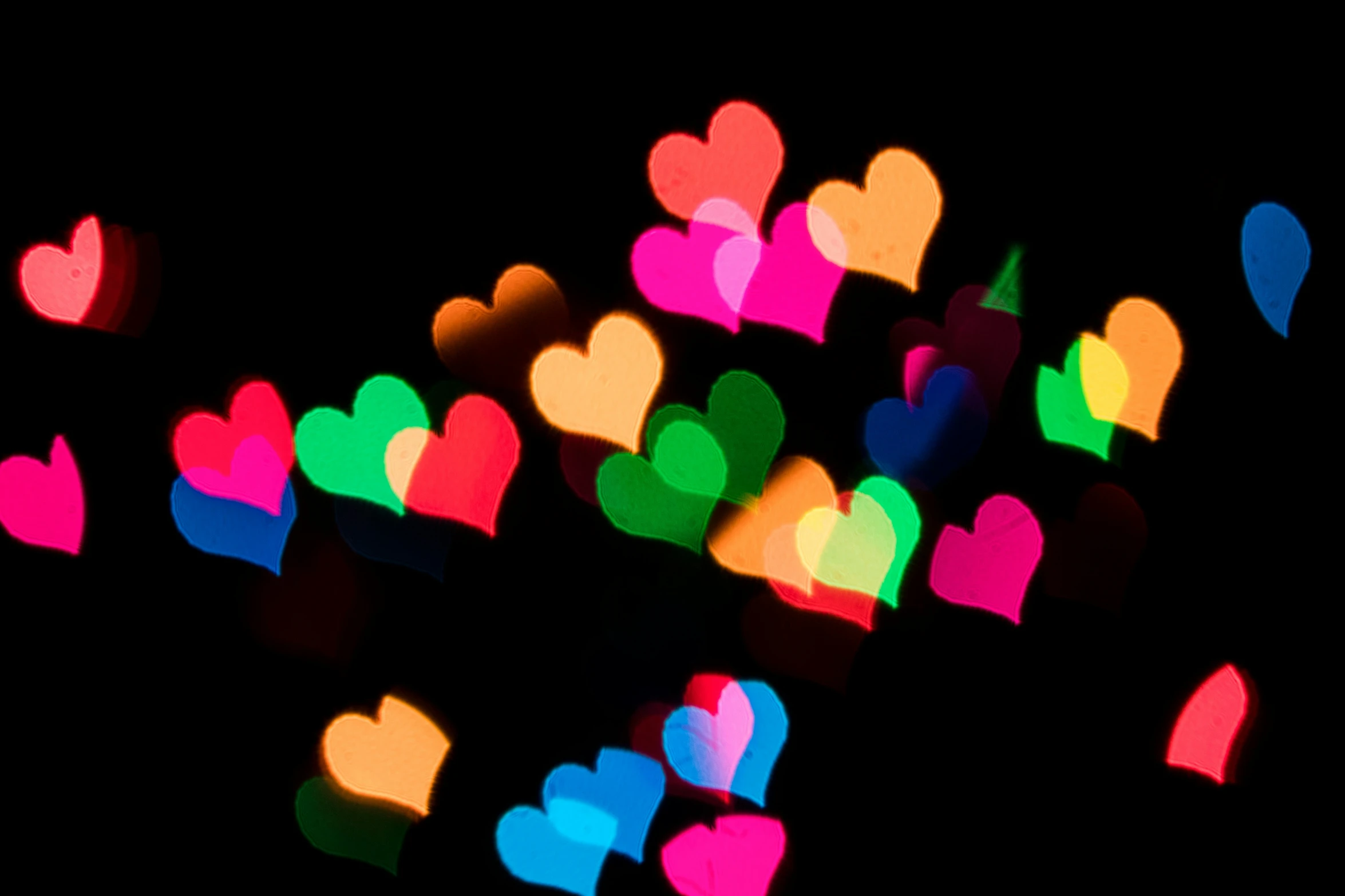 brightly colored heart shapes being displayed on black