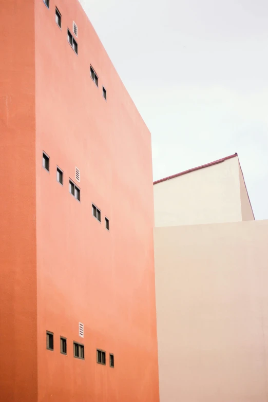 this orange building has five windows along the front wall