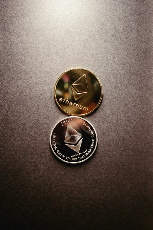 two coins side by side sitting on a table