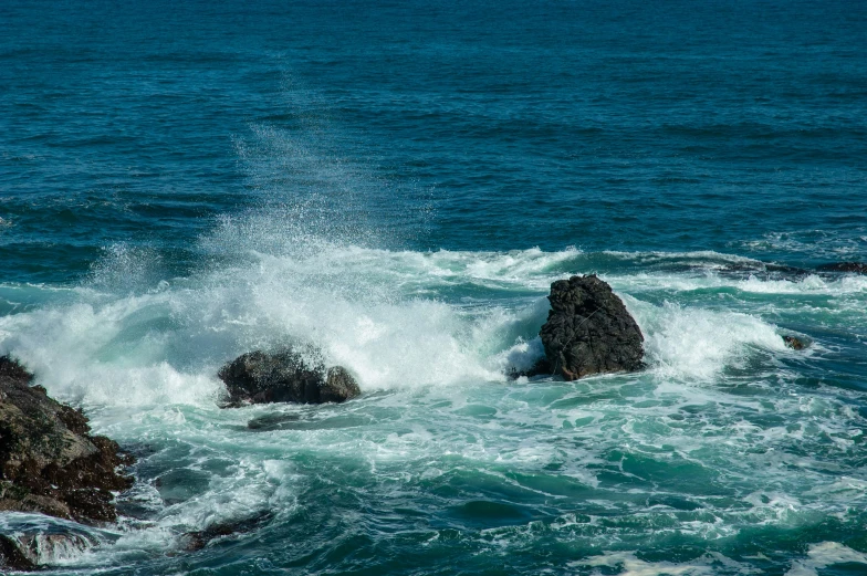 the rocks on the ocean shore are covered with water