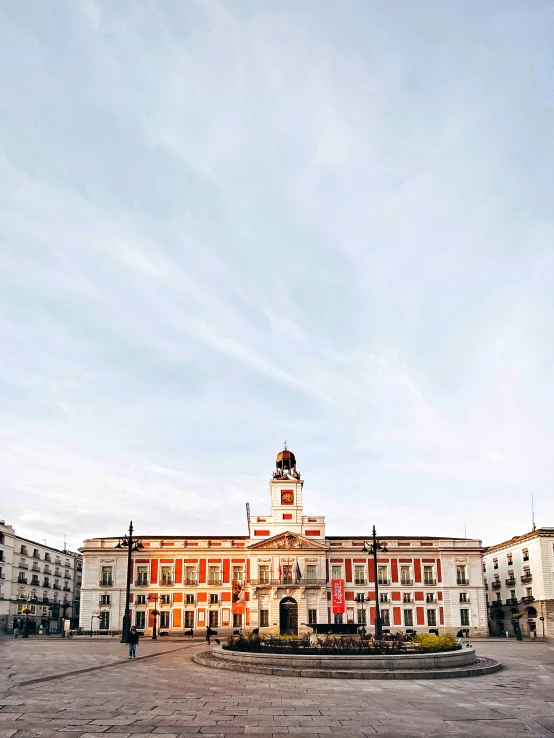 a plaza surrounded by multiple buildings and a clock tower