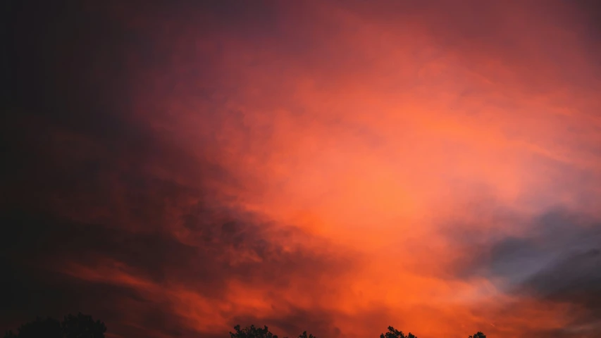 the clouds are pink and orange in the evening sky