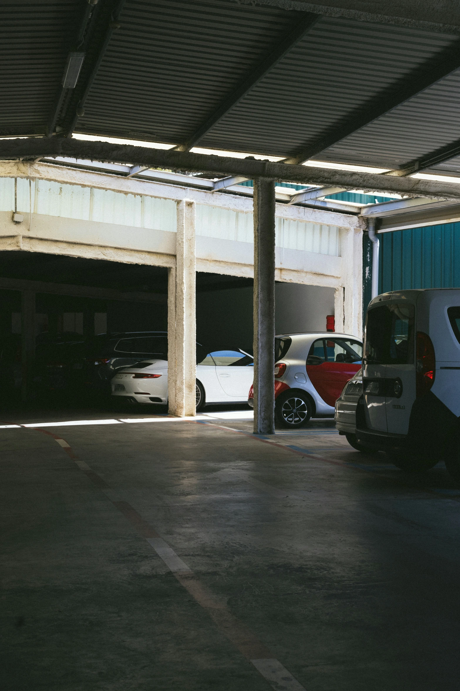 two cars parked in an open car port