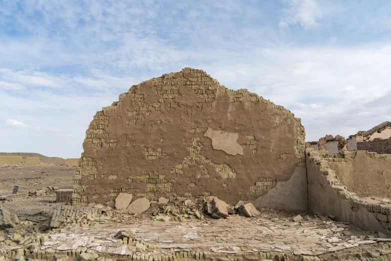 a building is sitting in a dirt field