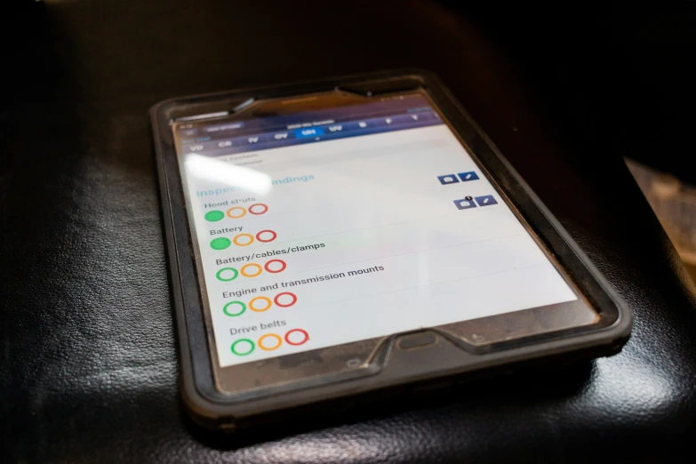 a smart phone on top of a leather desk