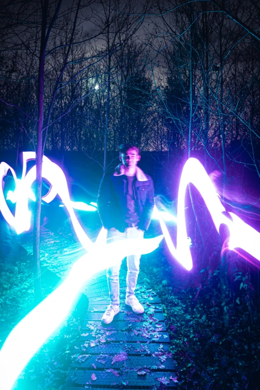 a man standing on a trail of wood with glowing neon numbers