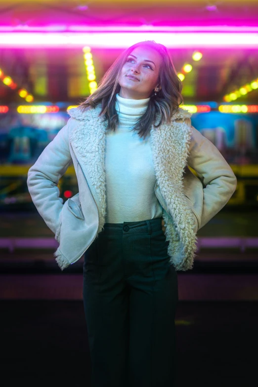 a woman stands in a neon show