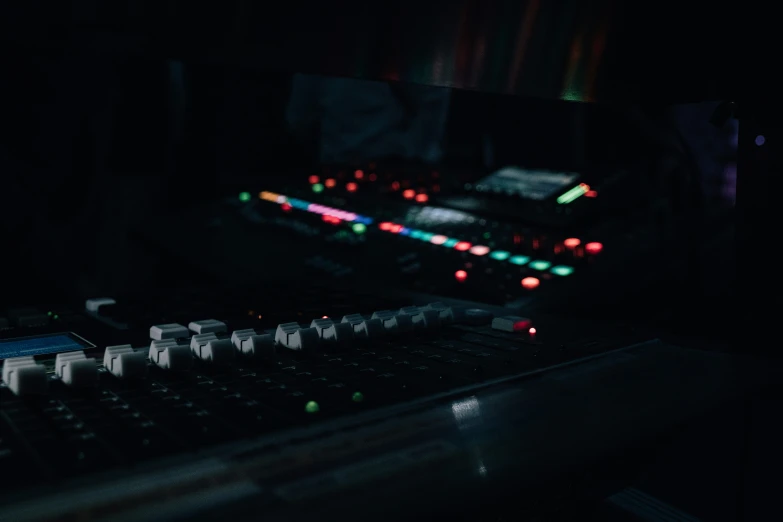 closeup of mixing console with dark background