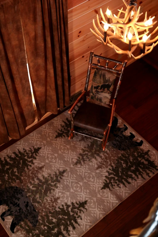 an old rocking chair and rug in the corner of a room