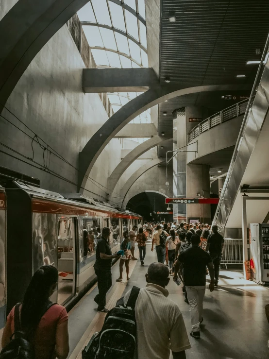 many people walking around in the subway station