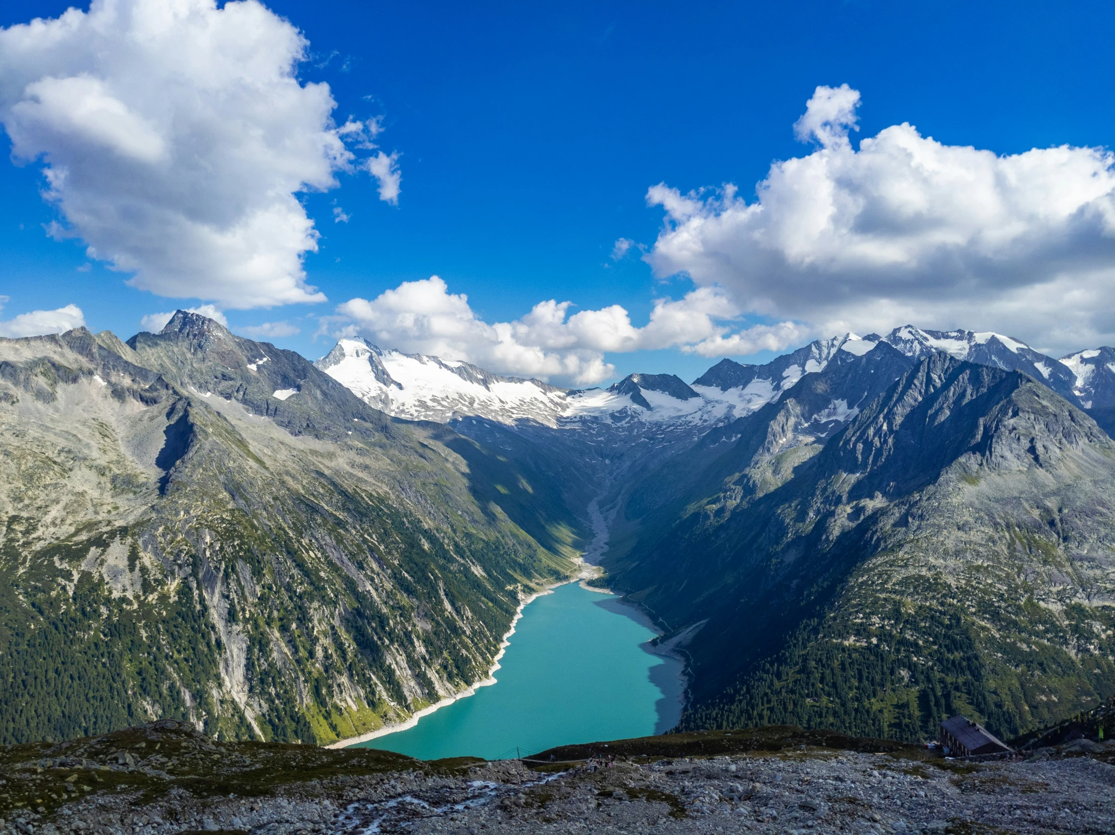 water in the middle of mountains with trees