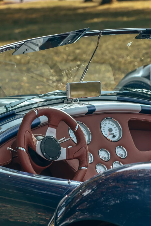 an older car with a gauge on the steering wheel