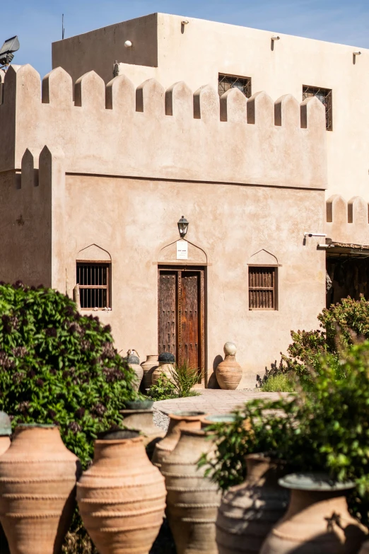 a building that has several pots in front of it