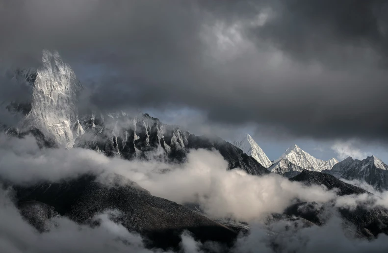 a large mountain is shown with clouds coming out
