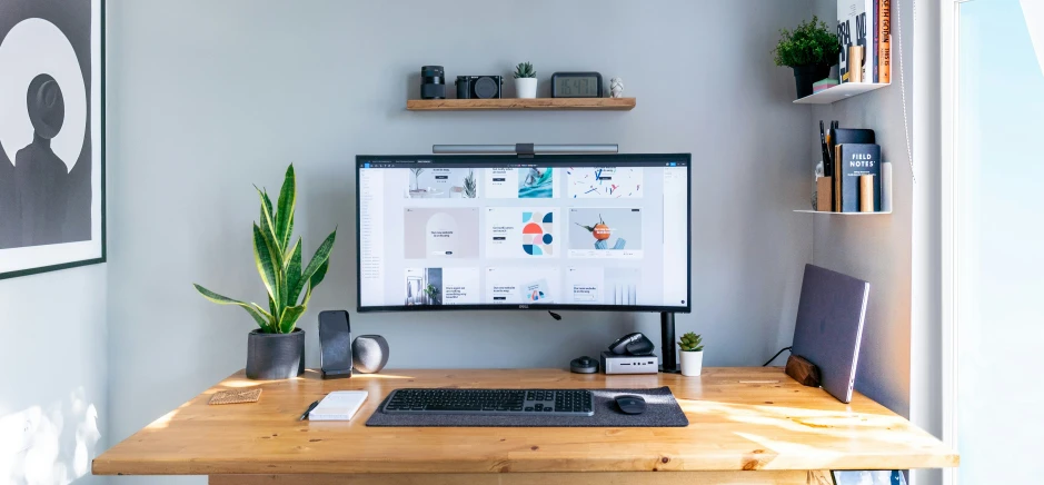 an office with a computer screen and books