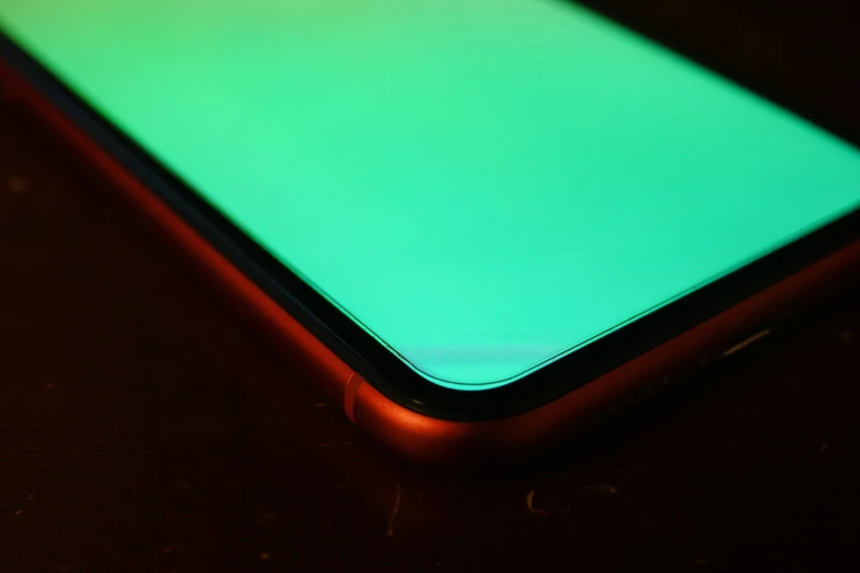 a close up view of a cell phone with the screen glowing green