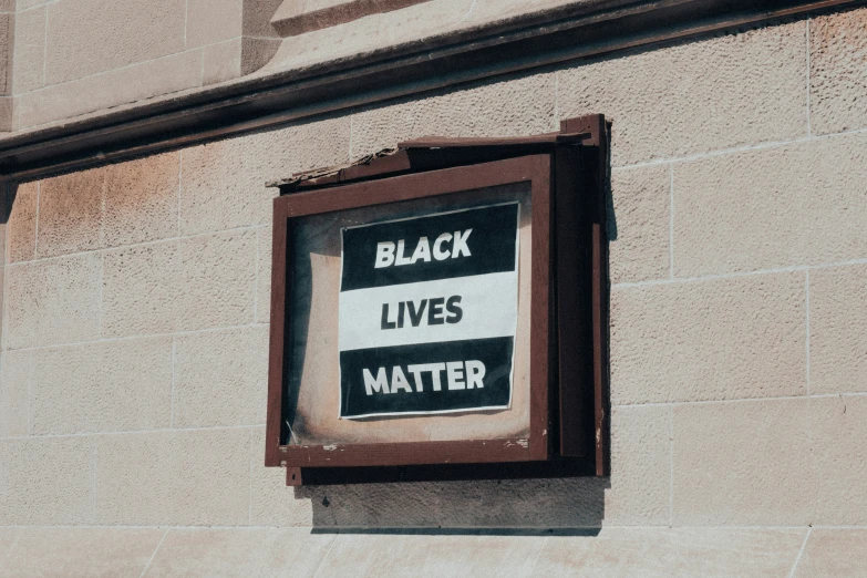 a sign on the outside of a building says black lives matter