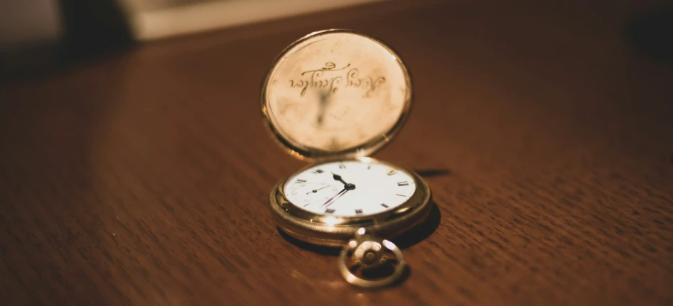 a pocket watch sitting on a table top
