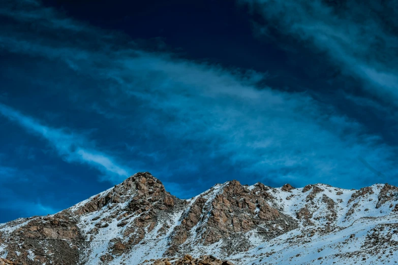 a scenic view of snow covered mountains in the evening