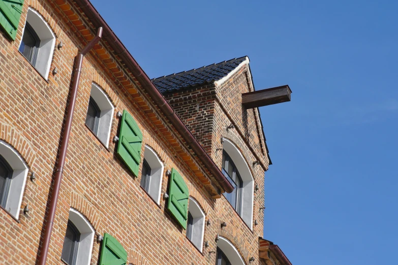 some green shutters and white windows and a clock