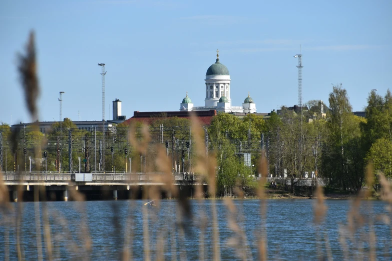 an old style building sits behind a large body of water