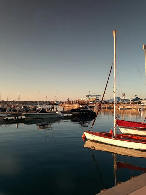 several boats docked in the water with their sails turned to read