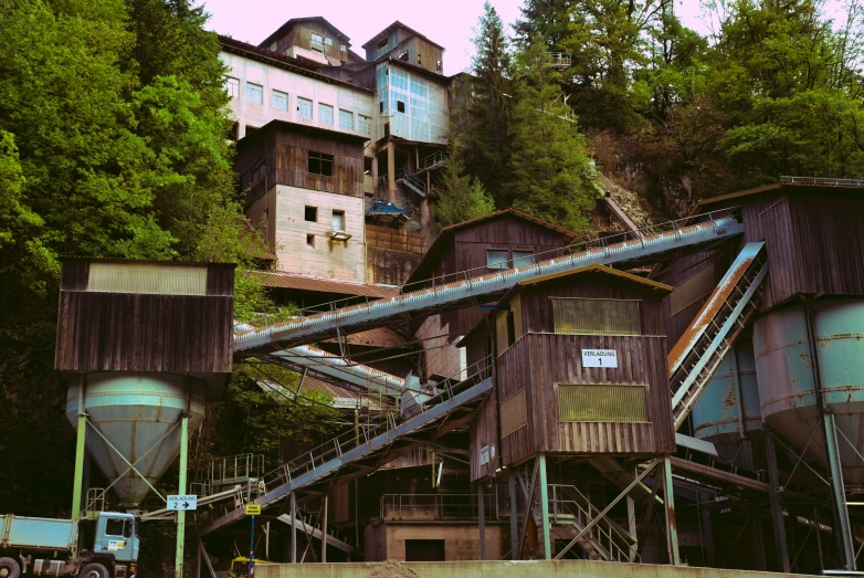 a row of buildings next to a lush green forest