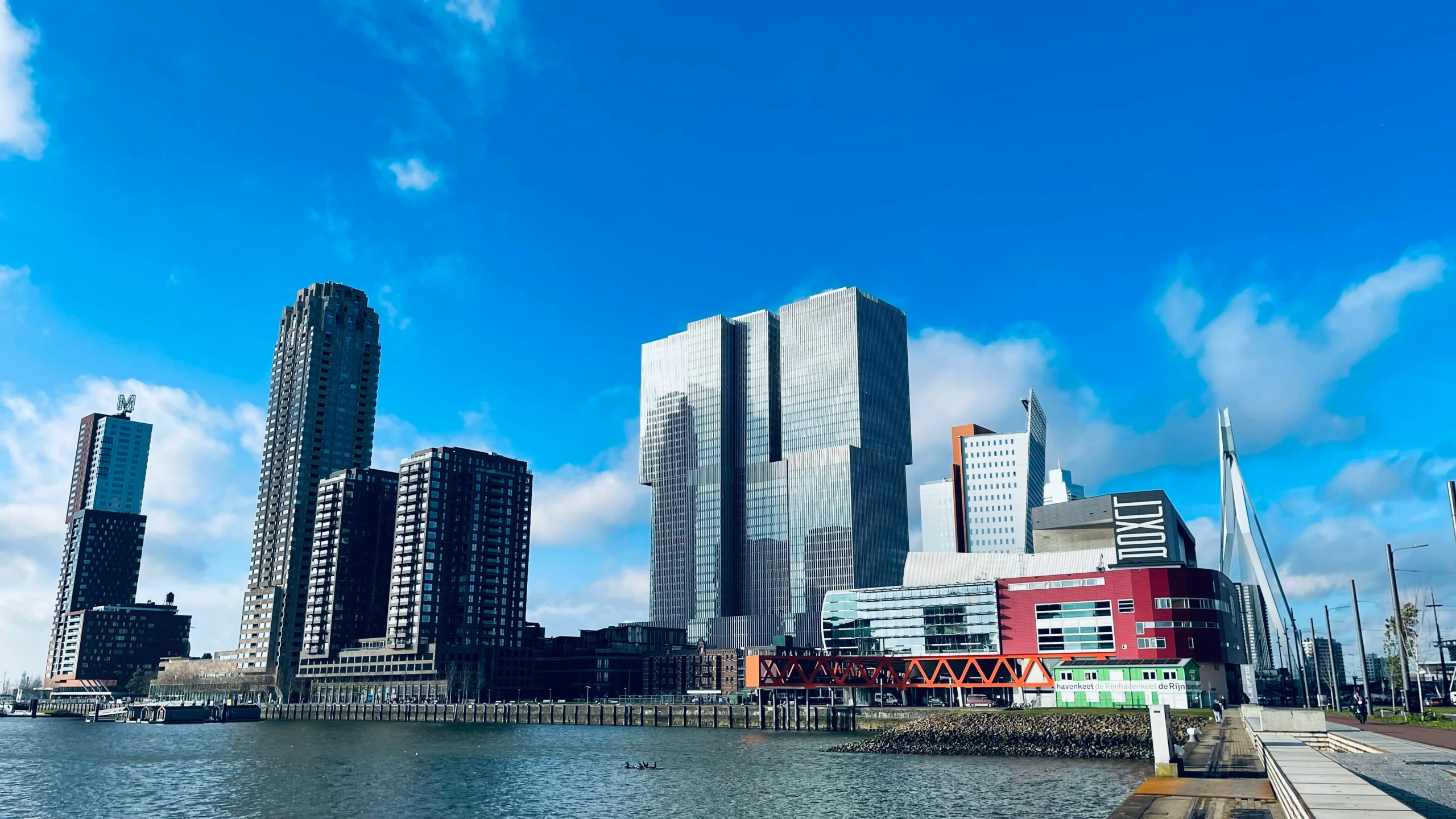 a bridge leading to some very tall buildings