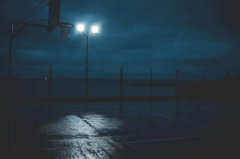 a basketball hoop sitting on the side of a basketball court