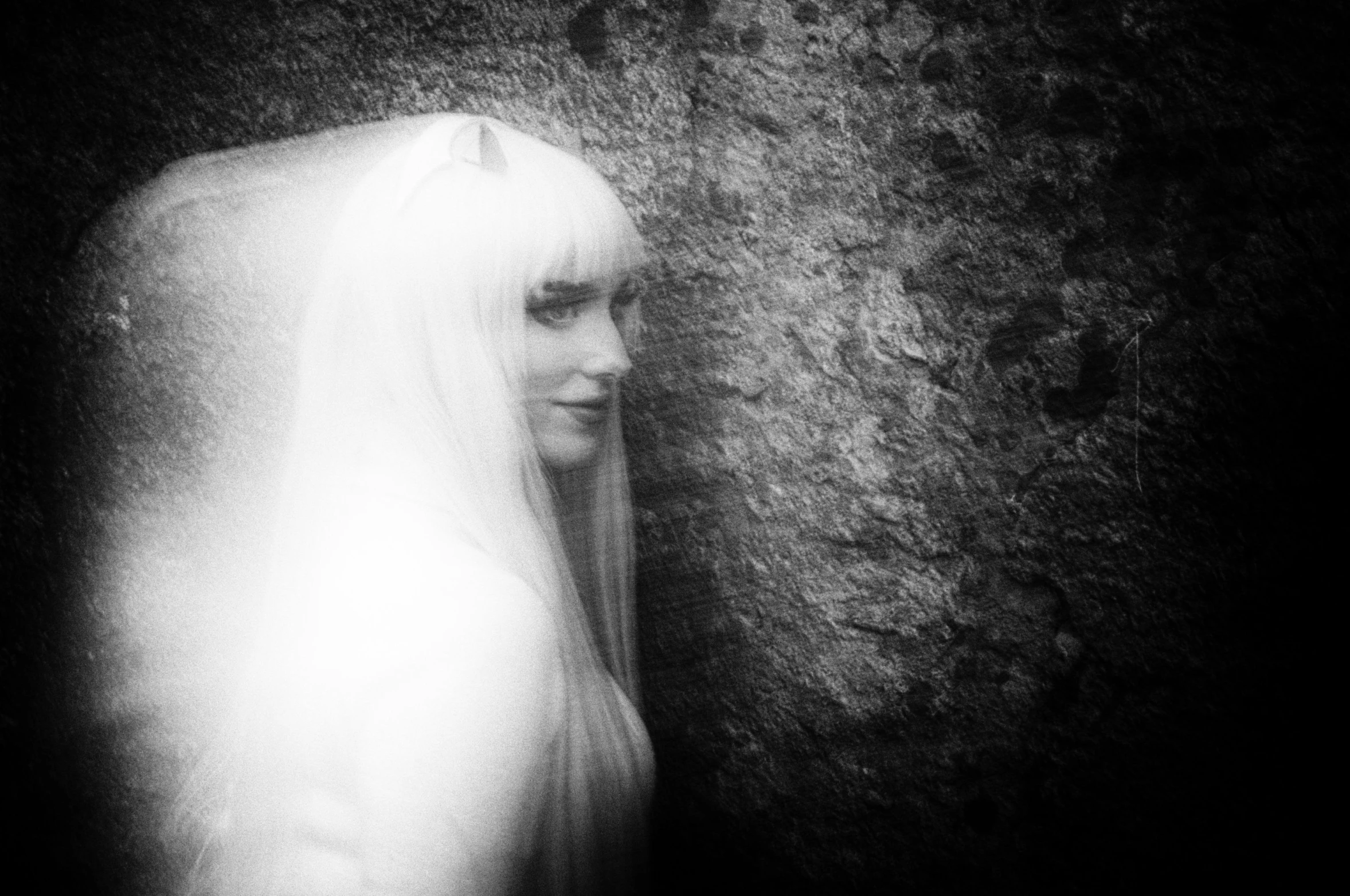 a woman with long hair in veil with black background