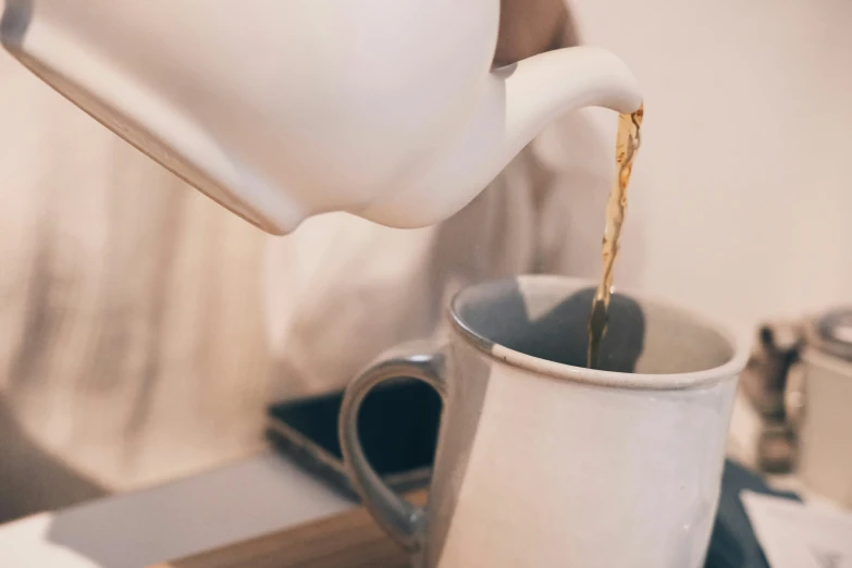 a coffee pot pouring coffee into it