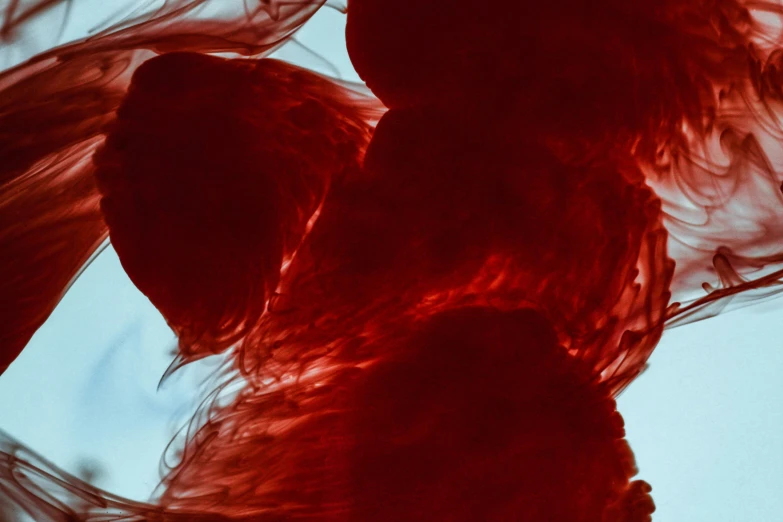 the back view of a woman's dress with a red wave behind her