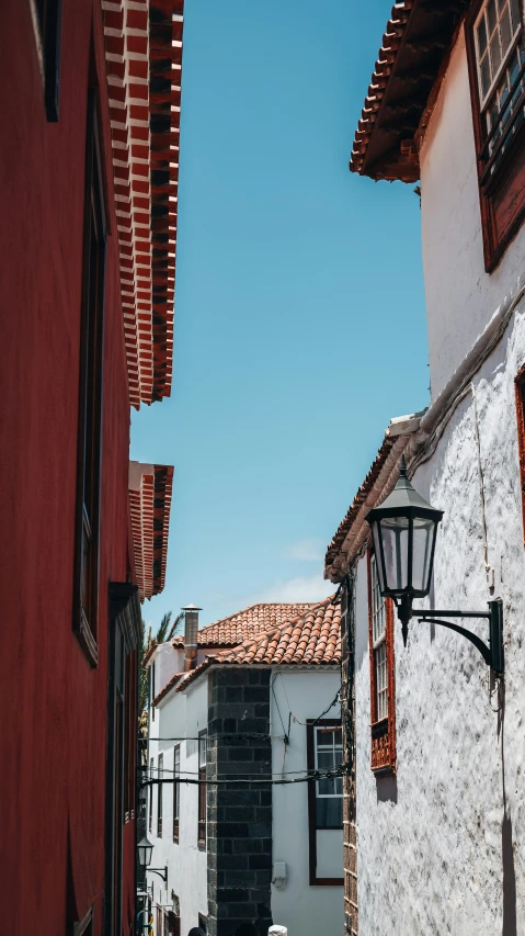 some windows red tile a street and buildings