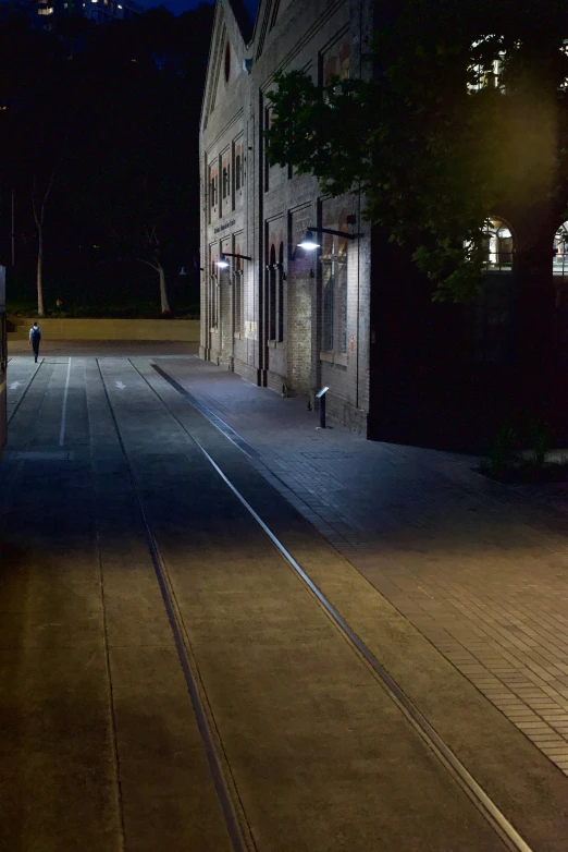 a city street with a train track at night