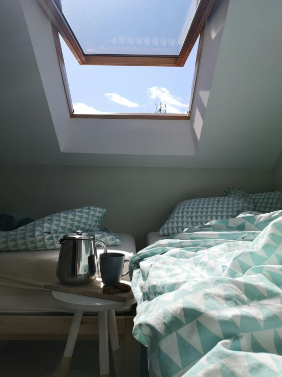 a room with skylight and some blankets