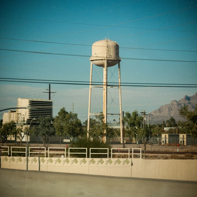 a view of a water tower in the middle of an urban area