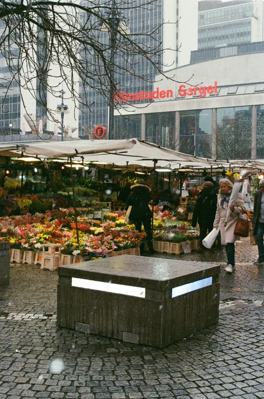 an open air market with people walking around