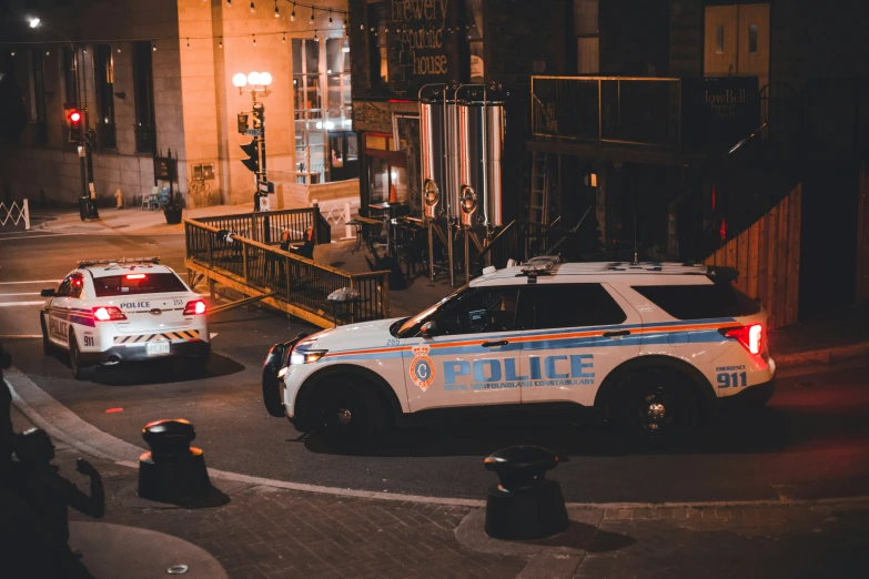 two police officers sitting outside an intersection at night