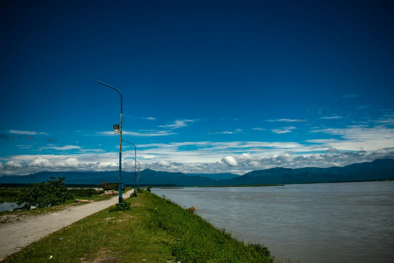 a street sign in front of water and mountains