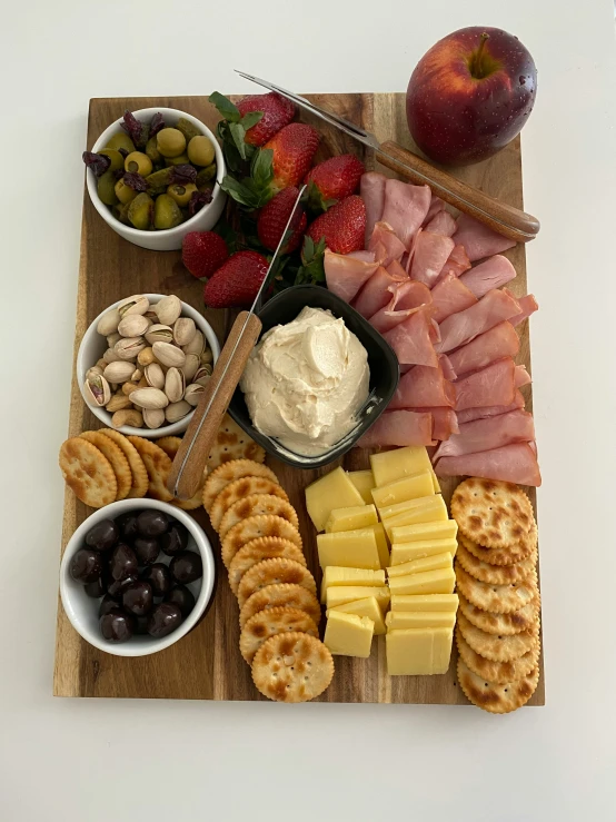 the platter has many different snacks and dips on it