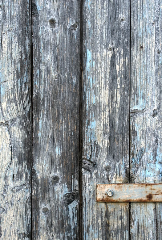 a old weathered wooden wall with a door handle