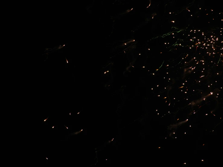 a nighttime sky view of a street sign and lights