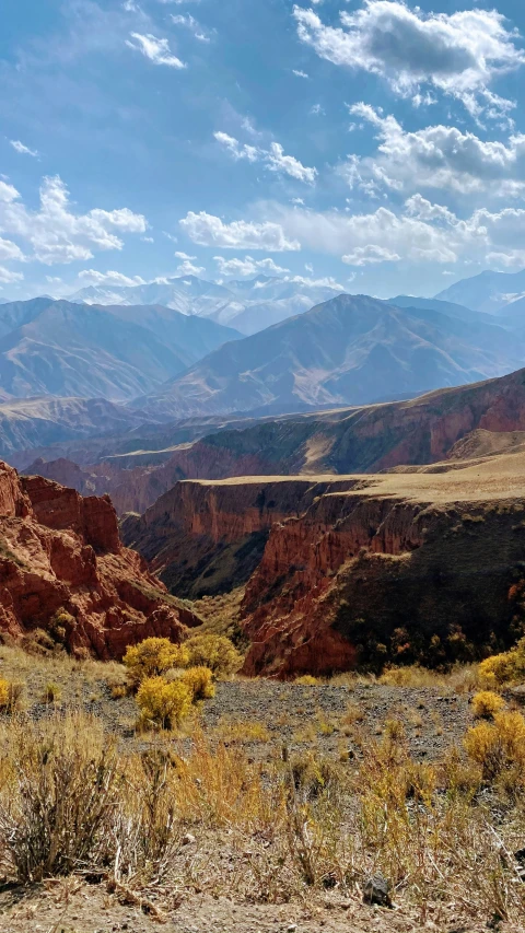 a wide, arid landscape shows rolling mountains and rolling valleys