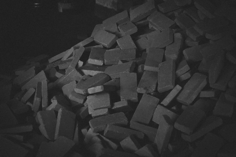 black and white pograph of bricks with a fire extinguisher